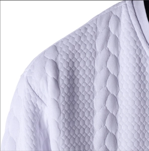 Detail of white baseball sweatshirt featuring 3D honeycomb and braided knit textures
