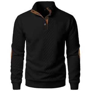 Macro detail of men's black knit sweater with stand collar and brown suede patchwork