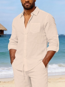 Detail of linen texture on cream men's beach shirt with adjustable button sleeves