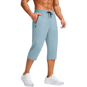Detail of light blue quick-dry capri pants featuring a black zipper with neon yellow pull cord