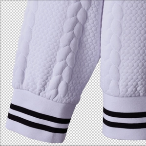 Detailed close-up of quilted honeycomb fabric and black striped ribbed cuffs on jacket