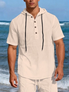 Detail of light beige linen short sleeve hooded shirt with buttons and black drawstrings