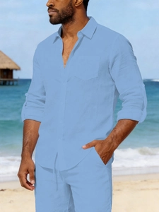 Close-up of light blue linen shirt featuring a turn-down collar and chest pocket detail