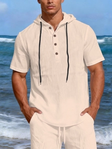 Close-up of linen-textured beige hooded shirt featuring dark buttons and beach style