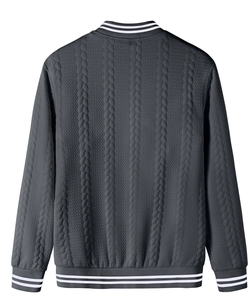 Macro detail of dark grey cable knit fabric with striped ribbed collar on baseball jacket