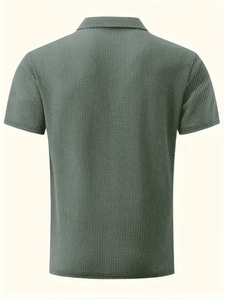 Detail view of the gray-green waffle texture fabric on a men's short sleeve polo shirt