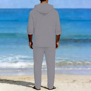 Rear view of men's casual grey linen hoodie set featuring adjustable sleeves on beach