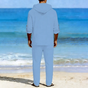 Rear view of men's light blue linen set featuring a hooded shirt and trousers on beach