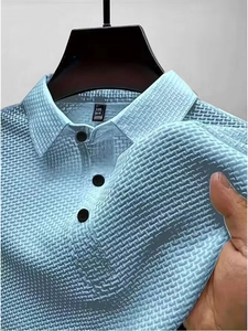 Close-up of light blue polo shirt with textured knit fabric and contrast buttons
