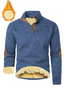 Detail of blue men's sweater featuring a button-up stand collar and thick yellow fleece lining