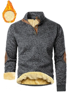 Detail of grey knit pullover featuring standing collar, buttons and yellow fleece lining