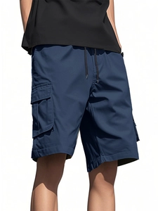 Detail of dark blue cargo shorts featuring 3D flap pockets and adjustable waist drawstring