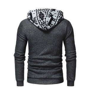 Detail of deer and snowflake jacquard knit pattern on the hood of a men's hoodie