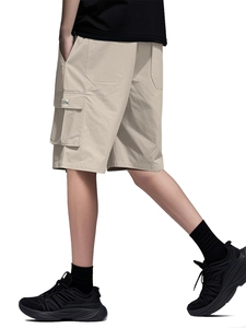 Detail shot of light khaki cargo shorts featuring a large side pocket and white label