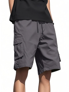 Detail view of grey cargo shorts featuring large side flap pockets and drawstring waist