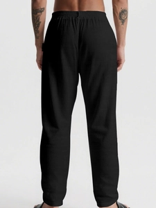 Rear view of breathable black linen trousers showing the elastic drawstring waist design