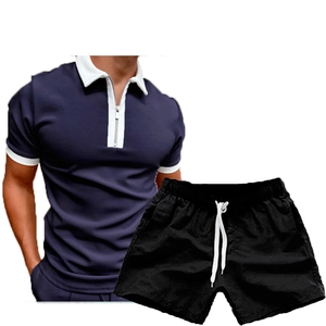 Detail of navy men's polo with contrast collar and black shorts with white drawstring