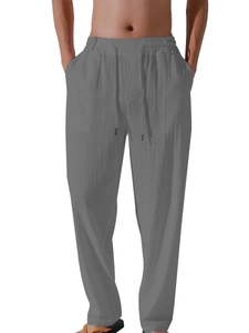 Detail of men's dark gray linen pants showing drawstring waist and breathable fabric
