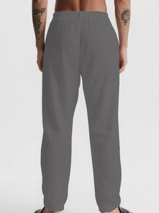 Detail of men's casual breathable pants showing elastic waistband and loose fit from behind