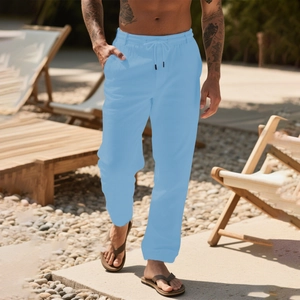 Men's light blue waffle knit linen pants with drawstring waist in beach setting