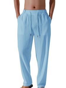 Detailed close-up of light blue linen trousers featuring elastic drawstring waistband and side pockets