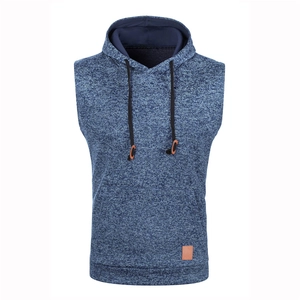 Detail view of knitted hooded vest featuring drawstring hood and kangaroo pocket with brown tag