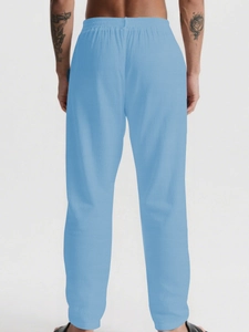 Detailed back view of men's breathable light blue linen trousers with elastic waistband