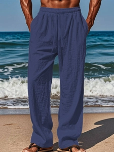 Detail of navy blue cotton linen trousers with elastic drawstring waist for beach wear
