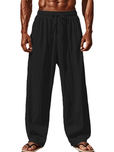Detail of men's breathable black cotton linen pants featuring drawstring waist and texture