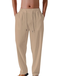 Close-up detail of khaki linen trousers featuring elastic drawstring waist and fiber texture