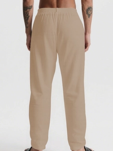 Rear view detail of men's khaki linen pants featuring elastic drawstring waistband