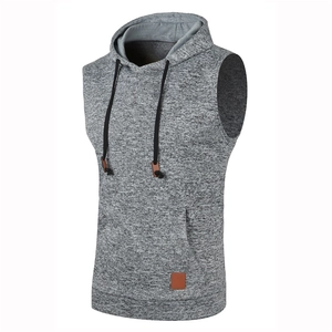 Detail of grey knitted hoodie vest featuring adjustable drawstring and kangaroo pocket