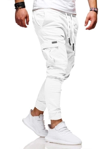 Detail of white cargo jogger pants with functional flap pockets and drawstring waist