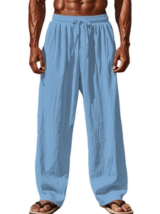 Close-up of light blue linen blend fabric texture and elastic drawstring waistband