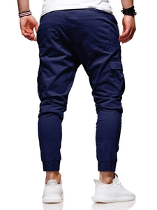 Rear view of navy blue jogger pants featuring ribbed cuffs and large back pockets
