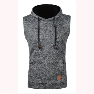 Detail of grey knitted hoodie vest featuring black drawstrings and brown faux leather patch