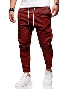 Close-up of wine red joggers featuring cargo side pockets and drawstring elastic waistband