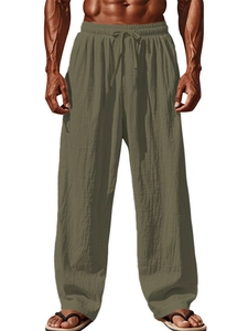 Detail of army green cotton linen pants featuring elastic drawstring waist and textured fabric