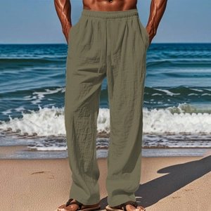 Detail of men's breathable cotton linen pants with drawstring waist on beach