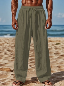 Detail of olive green cotton linen trousers featuring adjustable drawstring elastic waistband