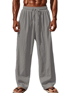 Detail of light gray cotton linen joggers showing elastic drawstring waistband and texture