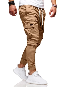 Detail of drawstring elastic waist and cargo pocket on khaki jogger pants