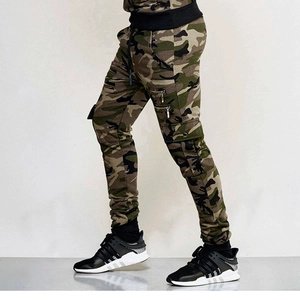 Detailed view of camouflage cargo pants featuring side zipper pockets and slim fit cuffs