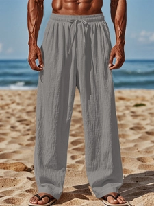 Close-up of men's gray linen cotton beach trousers featuring adjustable drawstring waist