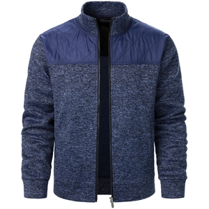 Detail of navy knit cardigan featuring quilted shoulder patches and smooth metal zipper closure