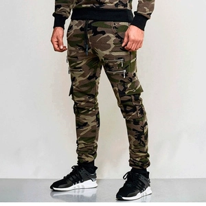 Detail of men's woodland camo joggers with multi-zipper pockets and elastic cuffs
