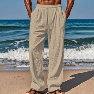 Detail of khaki linen-blend men's casual pants with drawstring waist on the beach