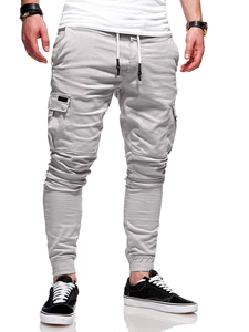 Detail of light grey cargo joggers featuring elastic drawstring waist and side patch pockets