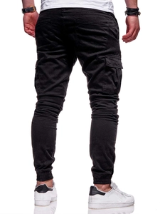Detail view of black cargo joggers showing 3D flap pockets and elastic cuffs on back