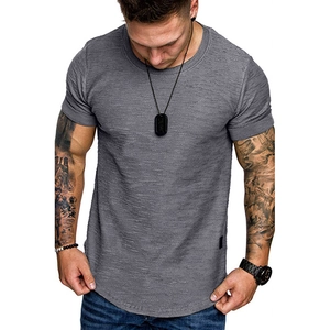Detail of grey men's crew neck t-shirt with textured fabric and curved hem design